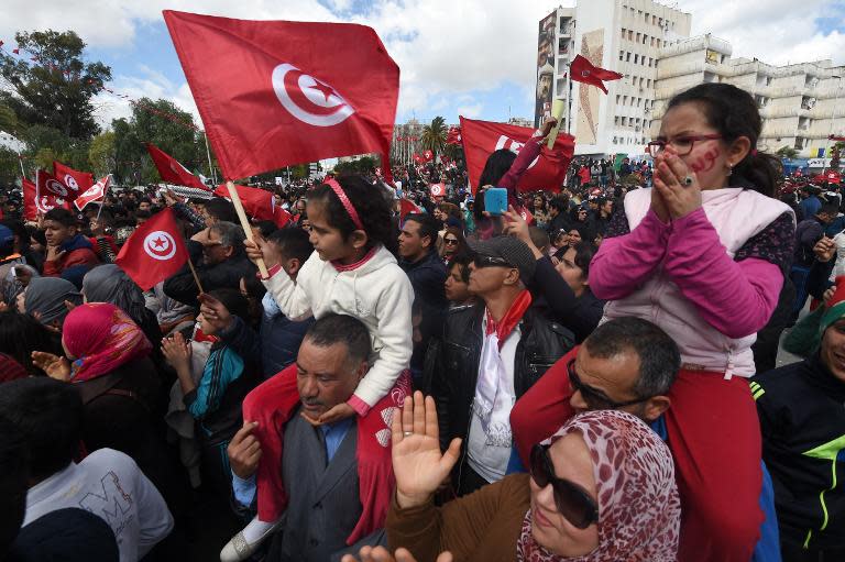 Chanting "Tunisia is free! Terrorism out!" the demonstrators marched in a sea of red Tunisian flags to the capital's Bardo Museum