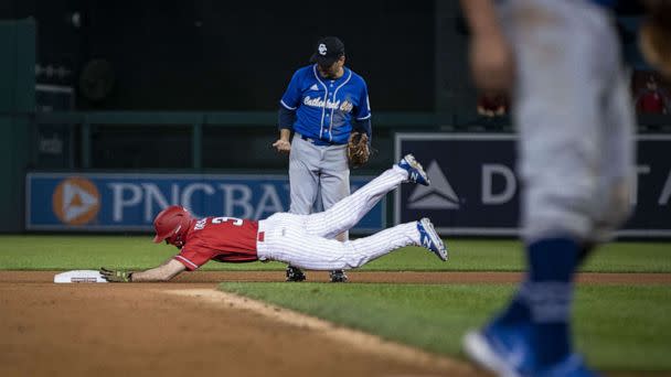 PHOTO: Rep. Nicholas Van Taylor, a Republican from Texas, slides into second base as Rep. Raul Ruiz, a Democrat from California, looks on during the Congressional Baseball Game at Nationals Park in Washington, Sept. 29, 2021. (Bloomberg via Getty Images, FILE)