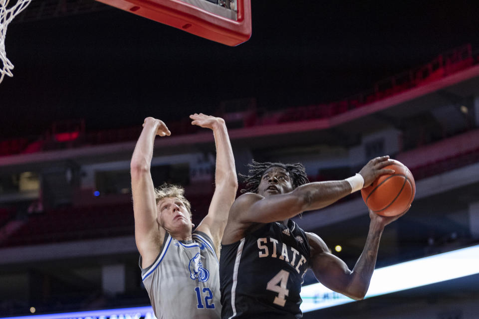 Mississippi State's Cameron Matthews (4) drives to the basket against Drake's Tucker DeVries (12) in the first half during an NCAA college basketball game, Tuesday, Dec. 20, 2022, in Lincoln, Neb. (AP Photo/John S. Peterson)