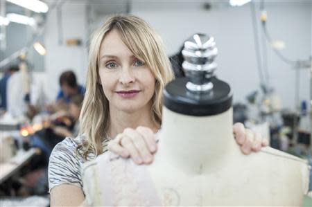 Fashion designer Rebecca Taylor stands with a mannequin wearing one of her creations in her studio in the Manhattan borough of New York, February 5, 2014. REUTERS/Keith Bedford