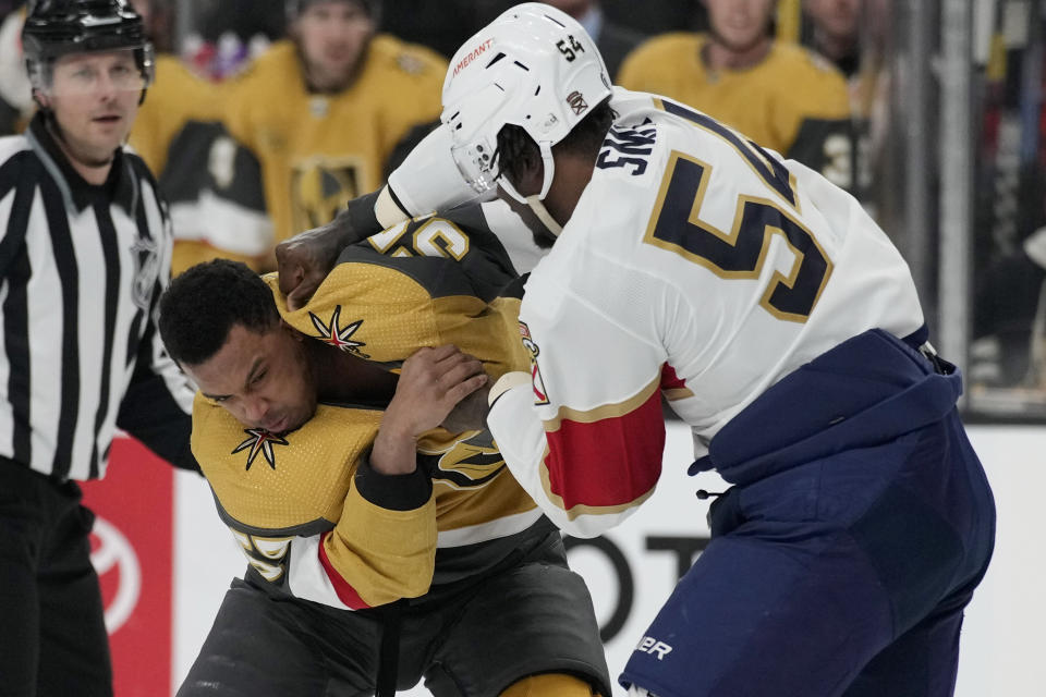 Florida Panthers right wing Givani Smith (54) and Vegas Golden Knights right wing Keegan Kolesar fight during the first period of an NHL hockey game Thursday, Jan. 12, 2023, in Las Vegas. (AP Photo/John Locher)