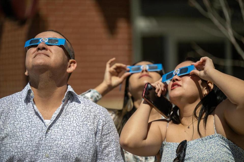 Guests watched the solar eclipse during a watch party at The Lawn at Legends Outlets on Monday, April 8, 2024, in Kansas City, Kansas. A solar eclipse happens when the Moon passes between the Sun and Earth, blocking the face of the Sun.