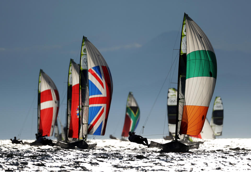 <p>Athletes from various countries compete in the men's skiff - 49er class race at Enoshima Yacht Harbour.</p>