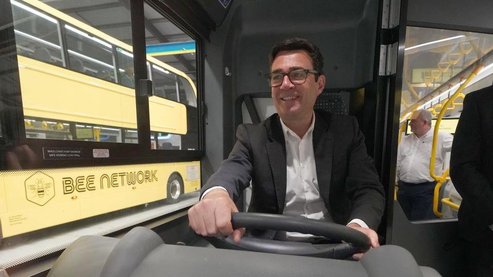 Greater Manchester mayor Andy Burnham sits in a new "Bee Network" bus