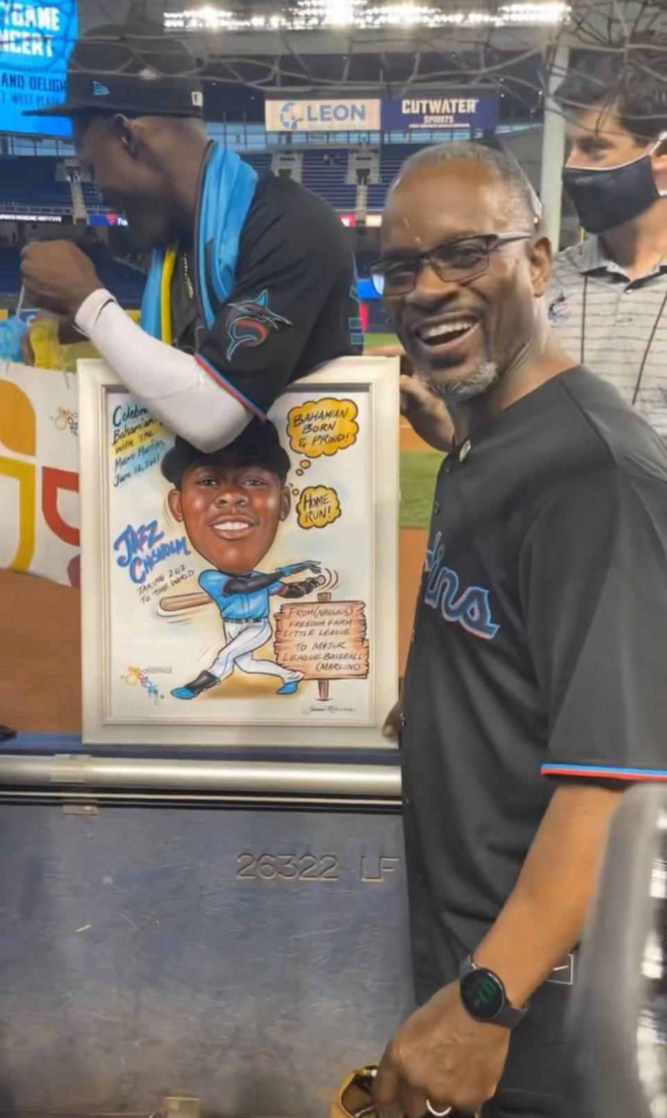 Bahamas Minister of Youth, Sports and Culture Iram Lewis presented a caricature painting to shortstop Jasrado “Jazz” Prince Hermis Arrington Chisholm Jr., a star rookie for the Marlins.