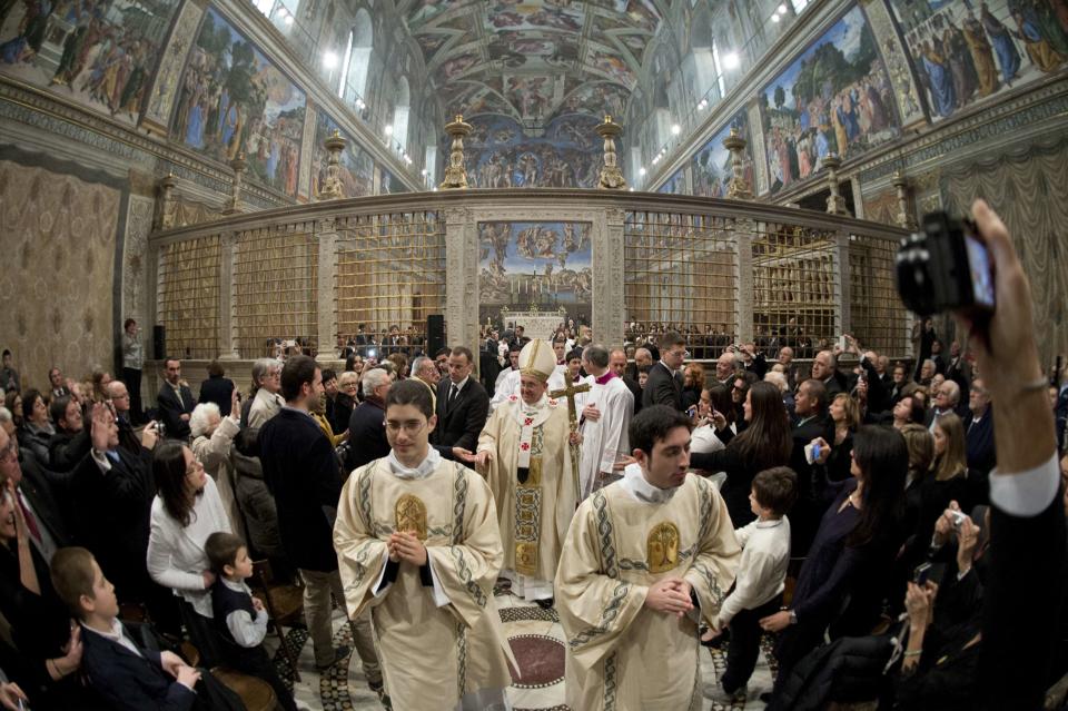 Pope Francis leaves at the end of a mass where 32 babies were baptized in the Sistine Chapel at the Vatican