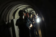 <p>Young Palestinians holding weapons walk in a tunnel during a military exercise graduation ceremony at a summer camp organised by Hamas’s armed wing, east of Gaza City July 22, 2016. (Mohammed Salem/Reuters)</p>