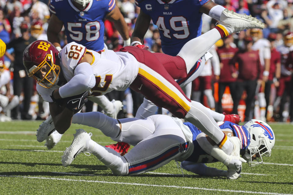 Washington Football Team's Logan Thomas (82) is tackled by Buffalo Bills' Micah Hyde (23) during the first half of an NFL football game Sunday, Sept. 26, 2021, in Orchard Park, N.Y. (AP Photo/Jeffrey T. Barnes)