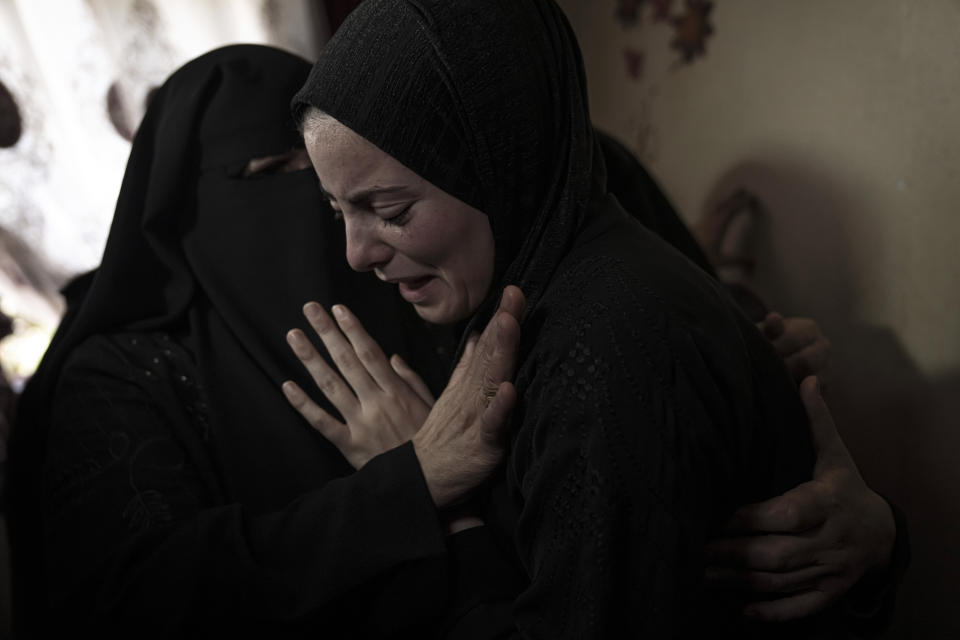 Mourners at the funeral for Islamic Jihad commander Ali Ghali, and his brother, Mohammed Ghali, both killed in an Israeli airstrike in Khan Younis, southern Gaza Strip, Thursday, May 11, 2023. (AP Photo/Fatima Shbair)