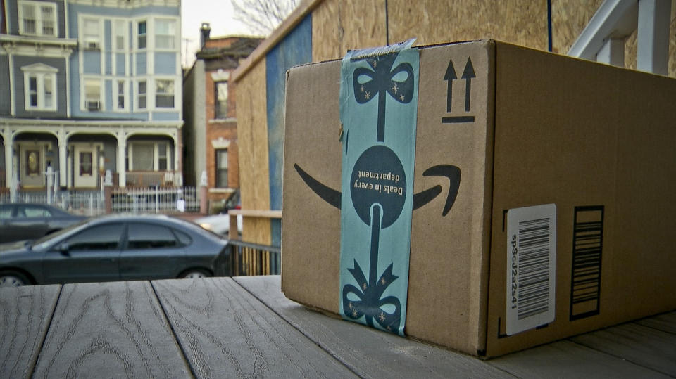 This image taken from video shows an Amazon package containing a GPS tracker on the porch of a Jersey City, N.J. residence after its delivery Tuesday, Dec. 11, 2018. The explosion in online shopping has led to porch pirates and stoop surfers swiping holiday packages from unsuspecting residents. The cops in one New Jersey city are trying to catch the thieves with some trickery of their own. (AP Photo/Robert Bumsted)