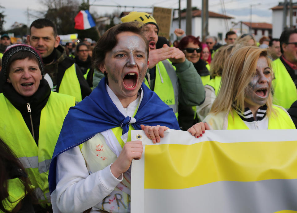 Yellow vest protesters shout slogans as they demonstrate in Saint Jean De Luz, France, Saturday, Jan. 19, 2019. Yellow vest protesters are planning rallies in several French cities despite a national debate launched this week by President Emmanuel Macron aimed at assuaging their anger.(AP Photo/Bob Edme)