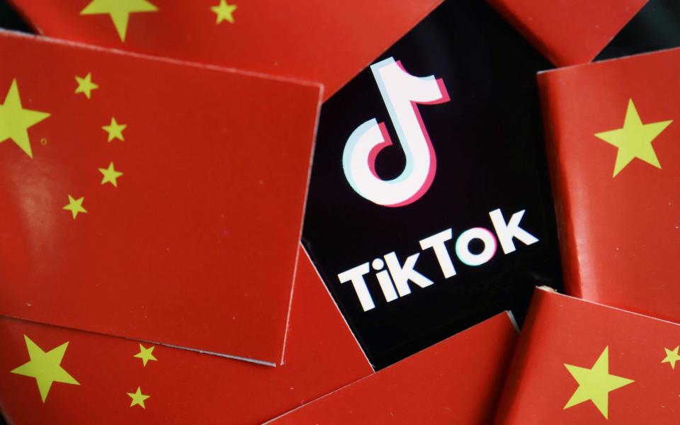 China's flags are seen near a TikTok logo in this illustration picture taken July 16 - Florence Lo/Reuters