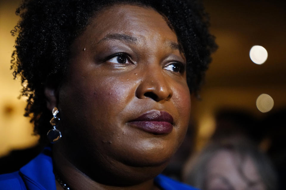 FILE - Georgia gubernatorial Democratic candidate Stacey Abrams talks to the media after qualifying for the 2022 election on Tuesday, March 8, 2022, in Atlanta. When she ended her first bid to become Georgia governor in 2018, Abrams announced plans to sue over the way the state’s elections were managed. More than three years later, as she makes another run at the governor’s mansion, the lawsuit filed in Nov. 2018 by Abrams' Fair Fight Action organization is finally going to trial on Monday, April 11. (AP Photo/Brynn Anderson, File)