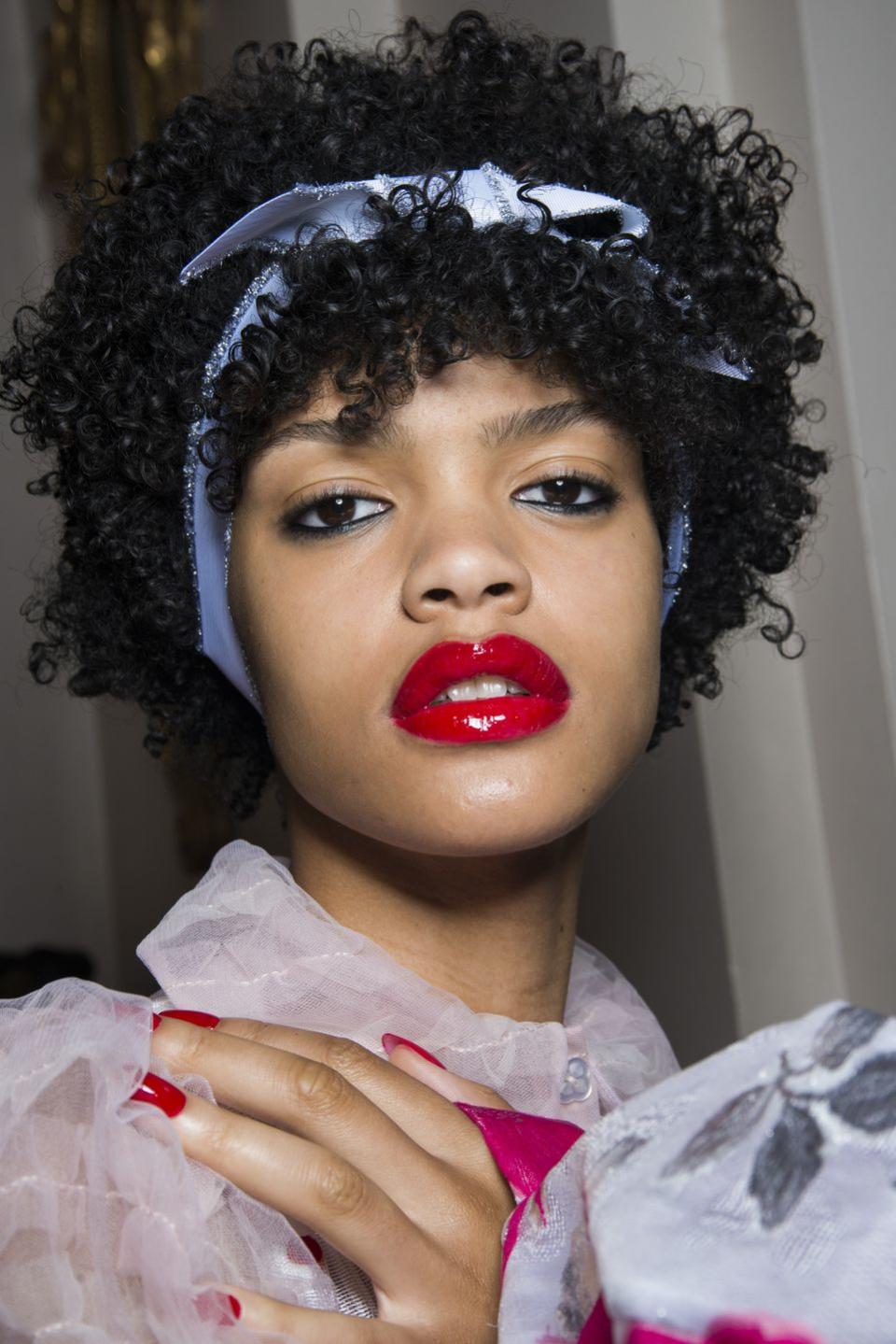 <p>Natural curls were accented with a length of powder blue ribbon backstage at Ryan Lo.</p>