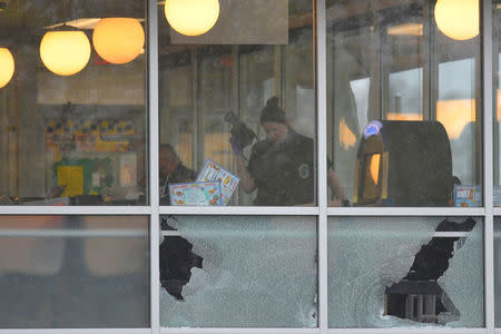 Metro Davidson County Police inspect the scene of a fatal shooting at a Waffle House restaurant near Nashville, Tennessee, U.S., April 22, 2018. REUTERS/Harrison McClary