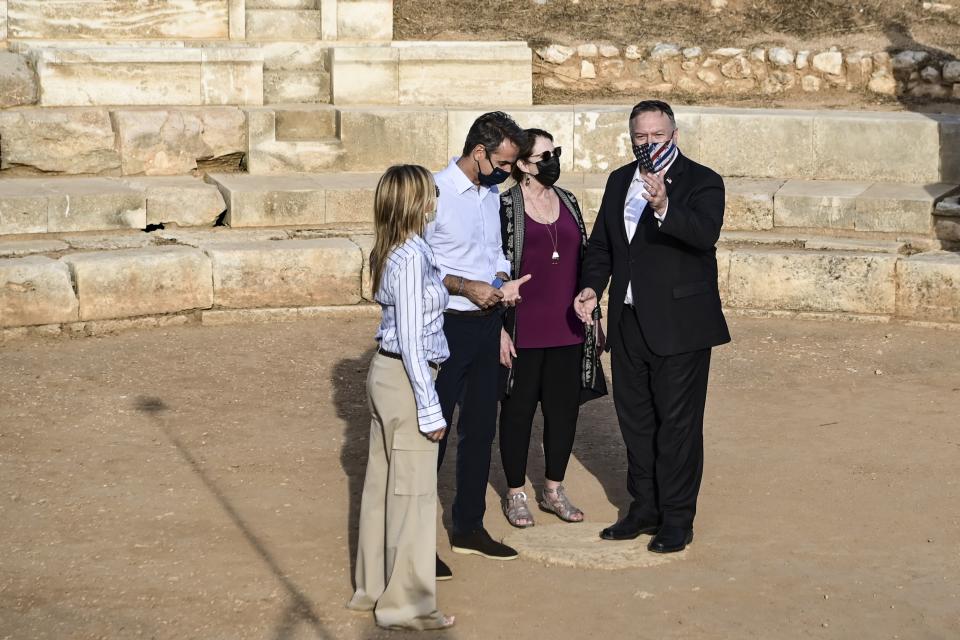 US Secretary of State Mike Pompeo, right, his wife Susan, second right, Greek Prime Minister Kyriakos Mitsotakis, second left, and his wife Mareva Grabowski visit the archeological site of Aptera, on the Greek island of Crete, on Tuesday, Sept. 29, 2020. U.S. Secretary of State Mike Pompeo has expressed support for talks between Greece and Turkey, NATO allies whose relations deteriorated to the point where both had warships facing off in the Mediterranean Sea. (Aris Messinis/Pool via AP)