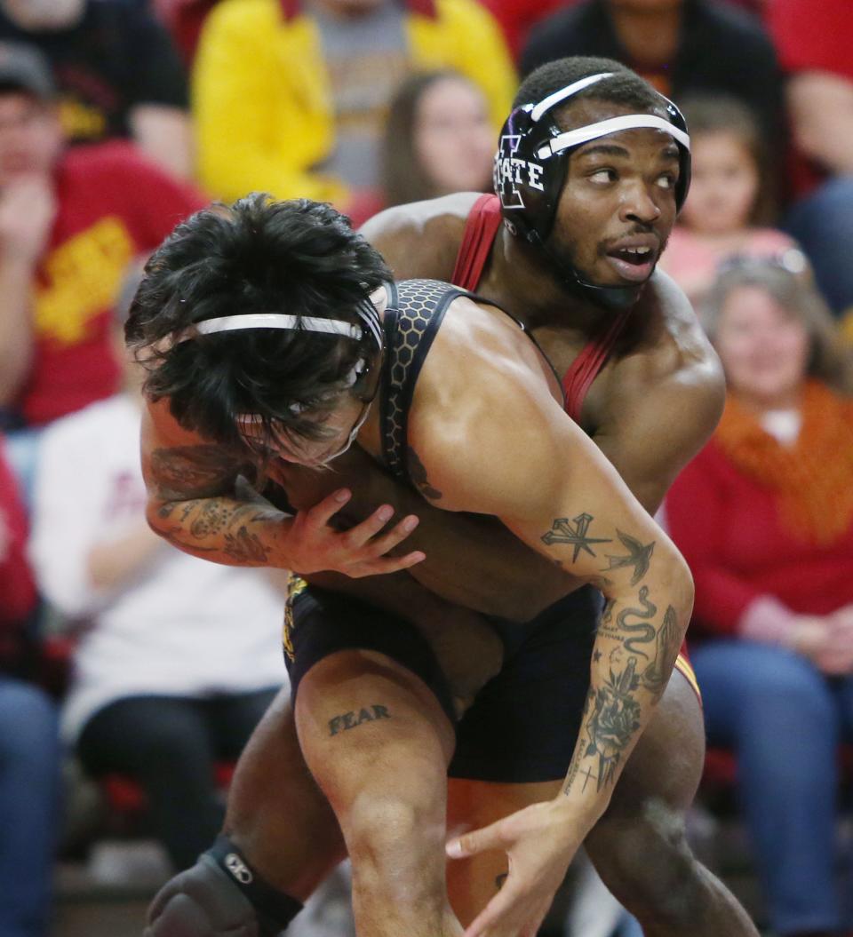 Iowa State Cyclones Paniro Johnson and Arizona Sun Devils Kyle Parco wrestle during their 149-pound wrestling in a dual meet at Hilton Coliseum.