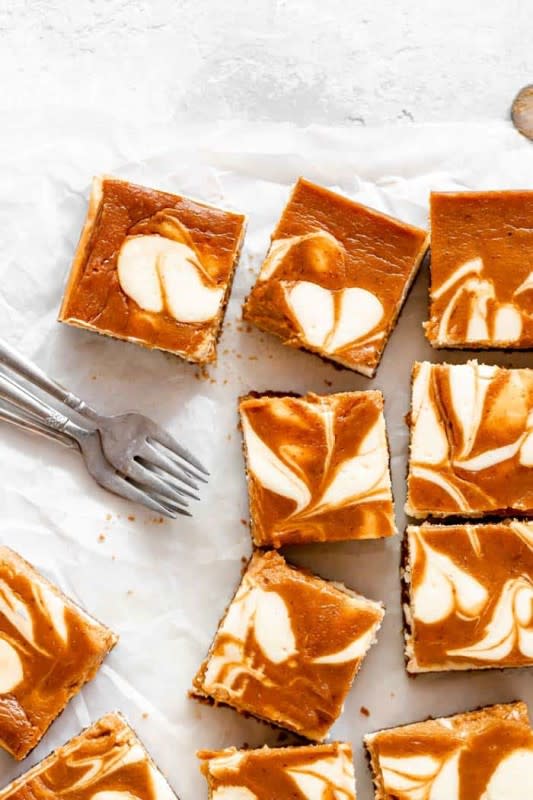 <p>Grandbaby Cakes</p><p>Perfectly fall-spiced pumpkin pie is swirled into rich decadent cheesecake baked on a crisp Biscoff cookie crust! </p><p><strong>Get the recipe: <em><a href="https://grandbaby-cakes.com/pumpkin-swirl-cheesecake-bars/" rel="nofollow noopener" target="_blank" data-ylk="slk:Pumpkin Swirl Cheesecake Bars;elm:context_link;itc:0;sec:content-canvas" class="link rapid-noclick-resp">Pumpkin Swirl Cheesecake Bars</a></em></strong></p>