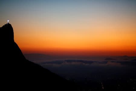 Christ the Redeemer is seen from the Vista Chinesa (Chinese View) during sunrise in Rio de Janeiro, Brazil, May 4, 2016. REUTERS/Ricardo Moraes