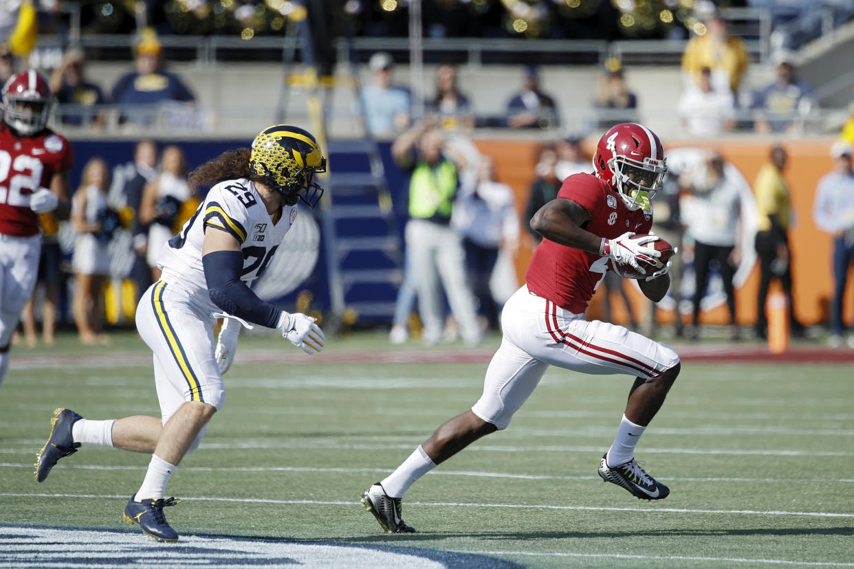 ORLANDO, FL - JANUARY 01: Jerry Jeudy #4 of the Alabama Crimson Tide runs after catching a pass against Jordan Glasgow #29 of the Michigan Wolverines in the first quarter of the Vrbo Citrus Bowl at Camping World Stadium on January 1, 2020 in Orlando, Florida. (Photo by Joe Robbins/Getty Images)