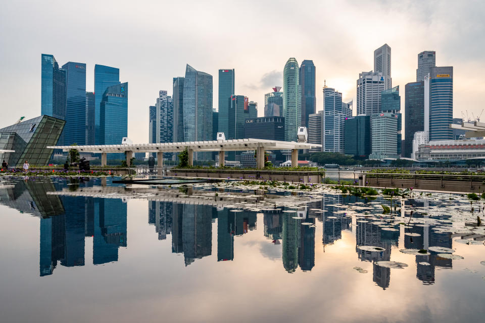 Skyscrapers of Marina bay financial district reflected with water reflection. Singapore