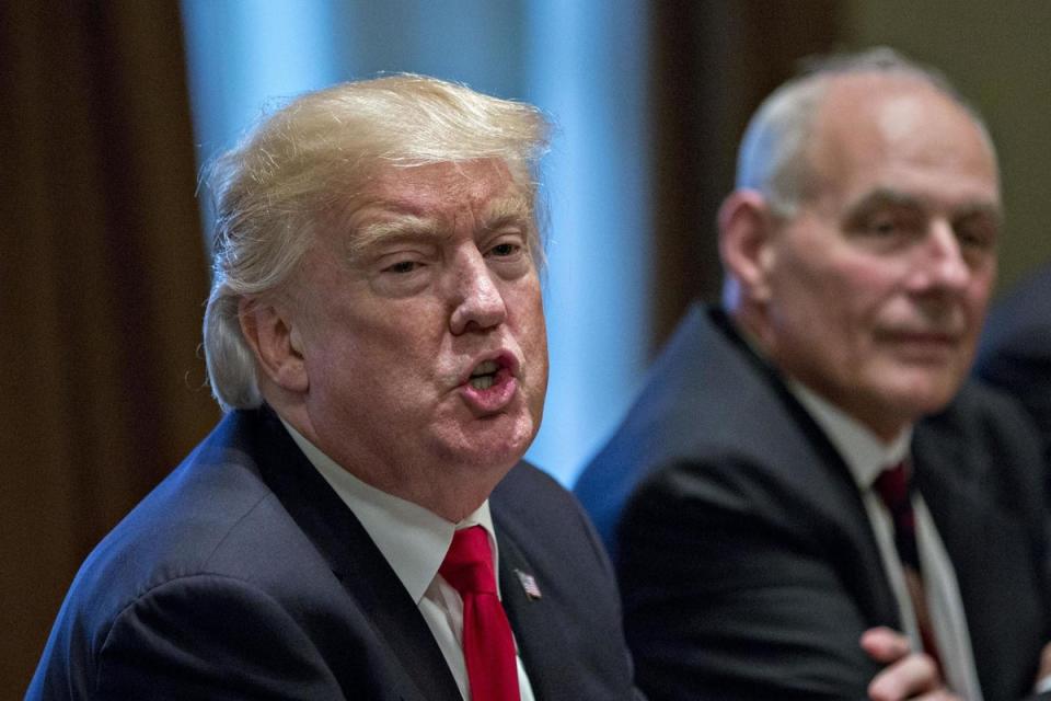 Former US President Donald Trump speaking in 2017, beside then-chief of staff John Kelly (Getty Images)