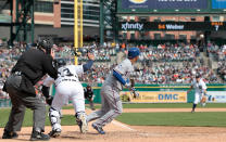 DETROIT, MI - APRIL 22: Alberto Gonzalez #14 of the Texas Rangers bunts for a single in the eleventh inning scoring Nelson Cruz #17 during the game against the Detroit Tigers at Comerica Park on April 22, 2012 in Detroit, Michigan. The Rangers defeated the Tigers 3-2. (Photo by Leon Halip/Getty Images)