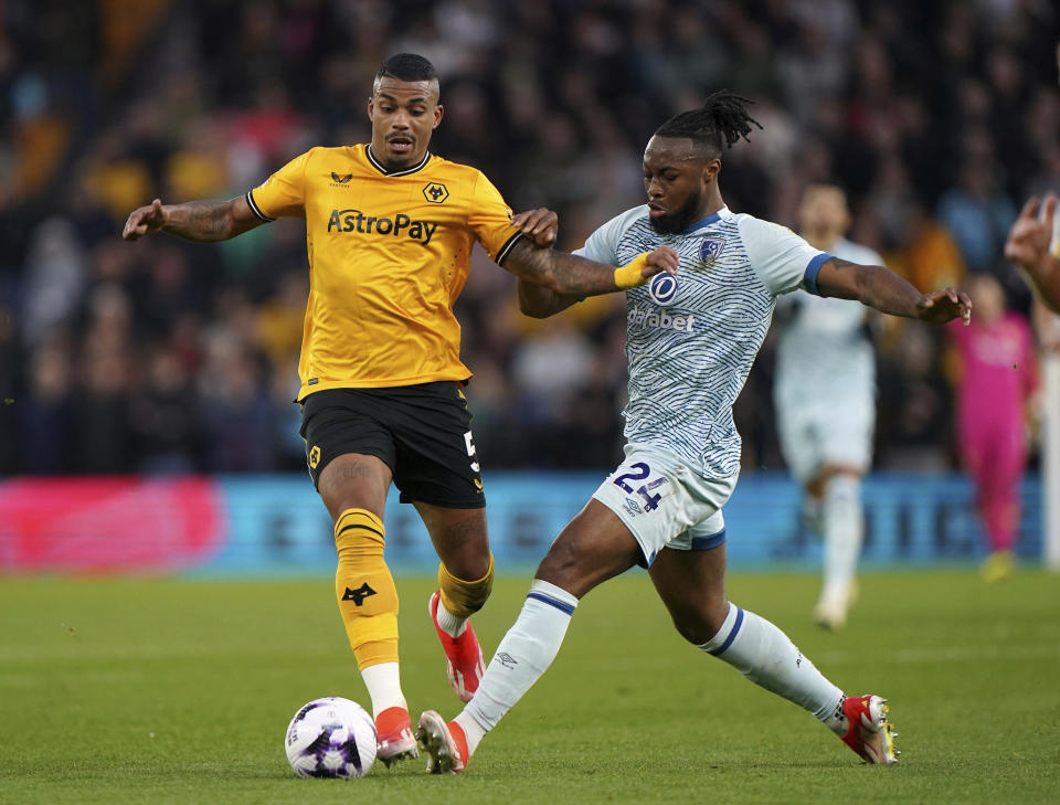 Wolverhampton Wanderers' Mario Lemina, left, and Bournemouth's Antoine Semenyo, challenge for the ball during the English Premier League soccer match between Wolverhampton Wanderers and Bournemouth in Wolverhampton, England, Wednesday, April 24, 2024. (Joe Giddens/PA via AP)