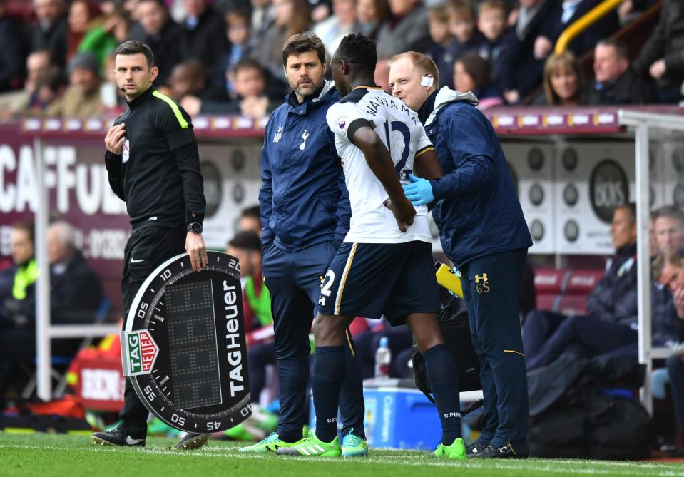 Tottenham’s Victor Wanyama receives medical treatment before being substituted off as Tottenham manager Mauricio Pochettino looks on