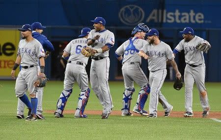 Oct 9, 2015; Toronto, Ontario, CAN; Texas Rangers players celebrate on the field after defeating the Toronto Blue Jays in game two of the ALDS at Rogers Centre. Mandatory Credit: Nick Turchiaro-USA TODAY Sports