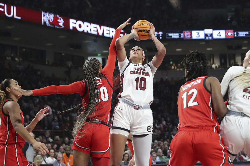 South Carolina center Kamilla Cardoso (10) is fouled by Georgia forward Jordan Cole (20) during the first half of an NCAA college basketball game, Sunday, Feb. 18, 2024, in Columbia, S.C. (AP Photo/Artie Walker Jr.)