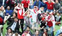 <p>Happy and glorious: Fans decked out in St George’s flags and England kits sing their hearts out for the Three Lions. (PA) </p>