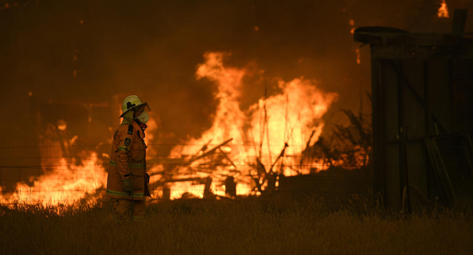 NSW Rural Fire Service crews fight the Gospers Mountain Fire as it impacts a property at Bilpin, Saturday.