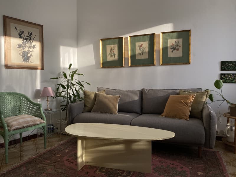 white living room with gray sofa, oblong coffee table, and green accent chair