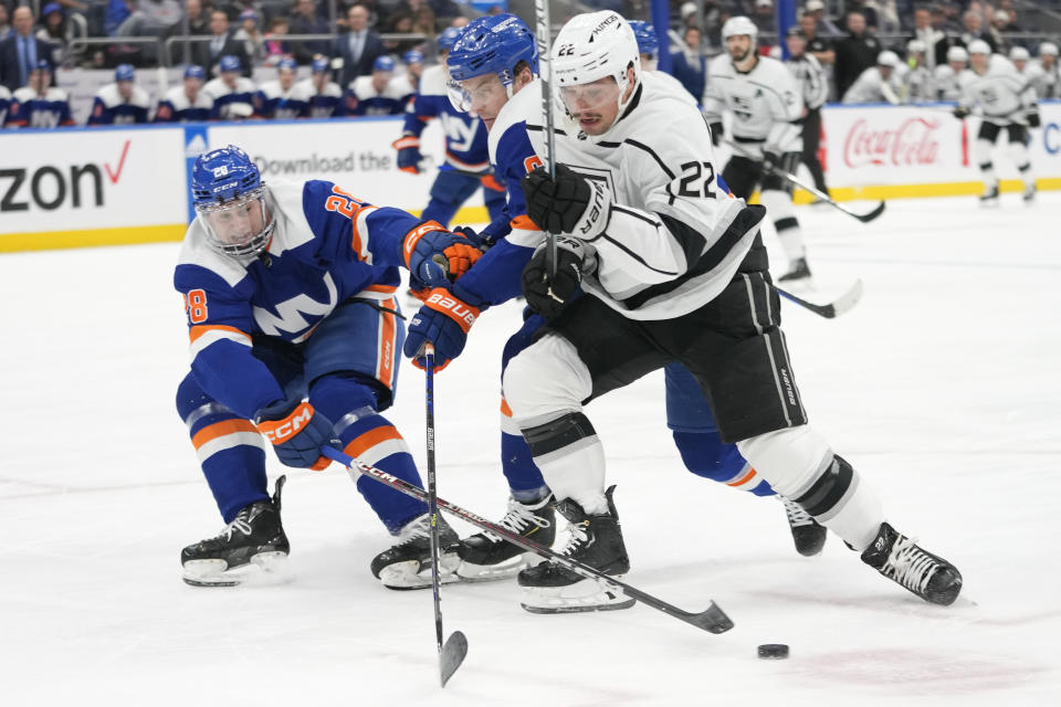 Los Angeles Kings left wing Kevin Fiala (22) skates against New York Islanders defensemen Alexander Romanov (28) and Ryan Pulock during the first period of an NHL hockey game Friday, Feb. 24, 2023, in Elmont, N.Y. (AP Photo/Mary Altaffer)