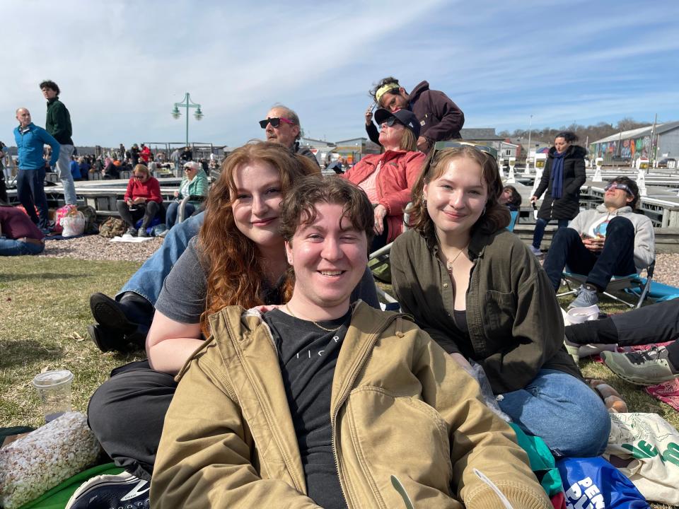 Aly Jewel, James Murphy and Gabby Flory sit on the grassy stretch of Perkins Pier Monday, April 8, 2024. The three UVM students live in Burlington, Vermont and came down the hill for a lakeside view.