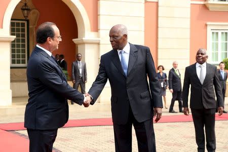 French President Francois Hollande shakes hands with Angolan President Jose Eduardo dos Santos before a news conference in Luanda, July 3, 2015. REUTERS/Herculano Coroado