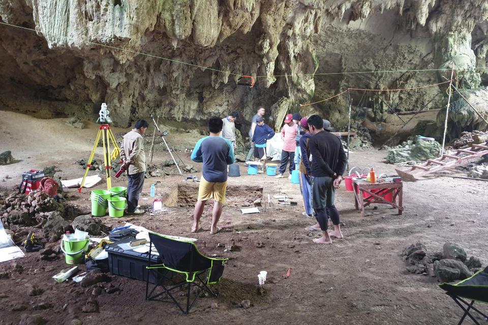 Workers stand in the cave in East Kalimantan, Borneo, Indonesia, where the human skeleton found dated to about 31,000 years ago, on March 1, 2020. The remains, which have been dated to 31,000 years old, mark the oldest evidence for amputation yet discovered. And the prehistoric “surgery” could show that humans were making medical advances much earlier than previously thought, according to the study published Wednesday, Sept. 7, 2022 in the journal Nature. (Photo Courtesy of Tim Maloney/Griffith University via AP)