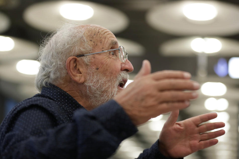 Swiss scientist Michel Mayor gestures after landing at the Barajas airport in Madrid, Tuesday, Oct. 8, 2019. Mayor has been jointly awarded the 2019 Nobel Prize in Physics along with Professor Didier Queloz and Professor James Peebles for their pioneering advances in physical cosmology, and the discovery of an exoplanet orbiting a solar-type star. (AP Photo/Manu Fernandez)