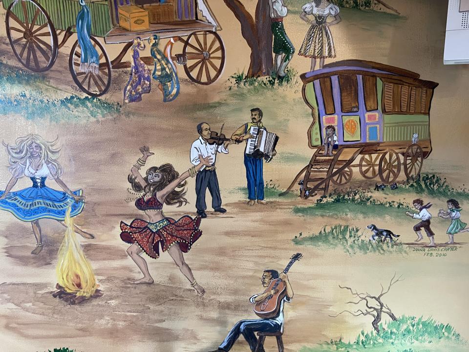 The murals aboard the bus depict wanderers and wagons. (Photo: Carly Caramanna)