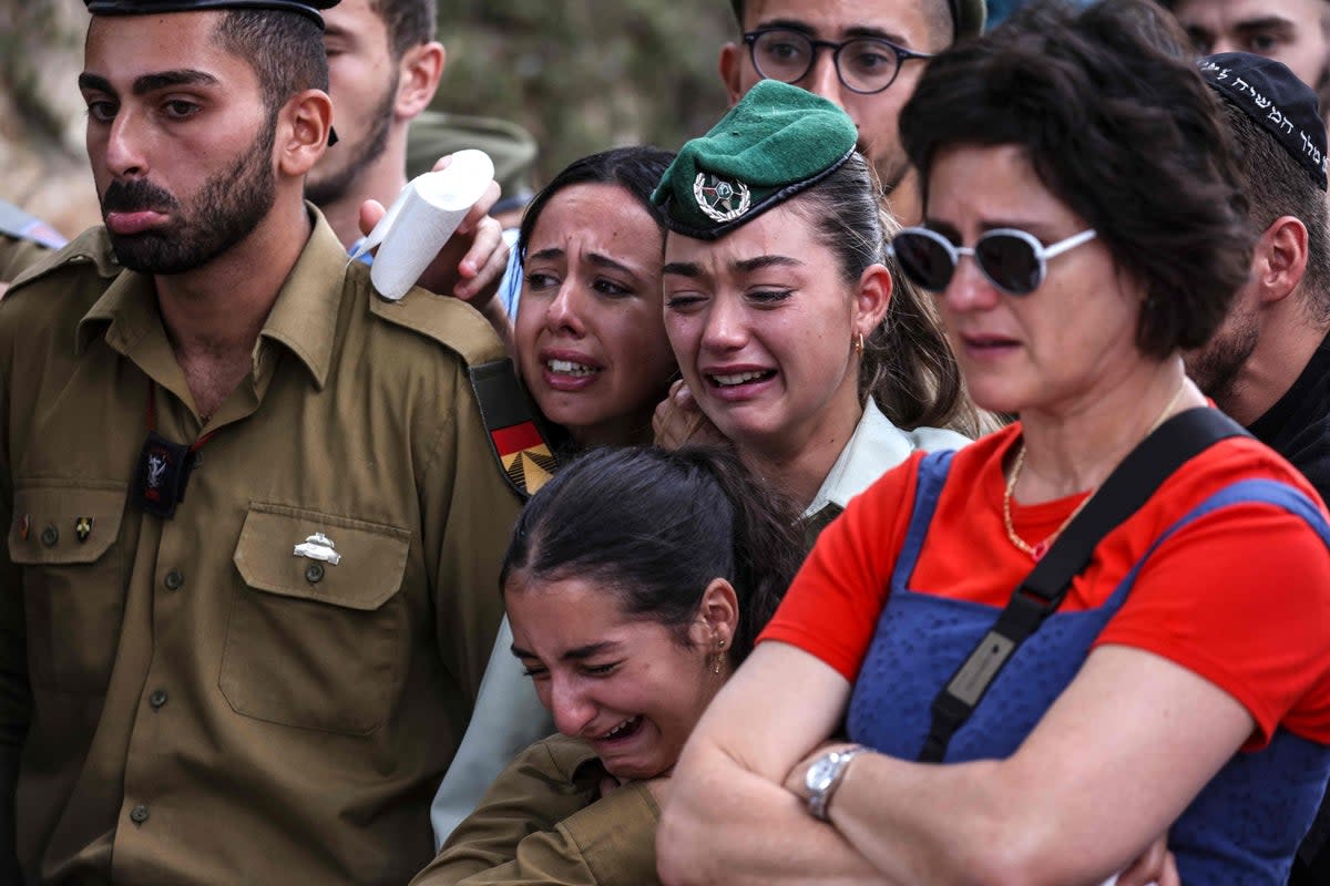 Comrades of French-Israeli soldier Eli Valentin Ghenassia, who was killed in combat at Kibbutz Be’eri during an attack by Hamas militants, mourn during his funeral on Thursday  (AFP via Getty Images)