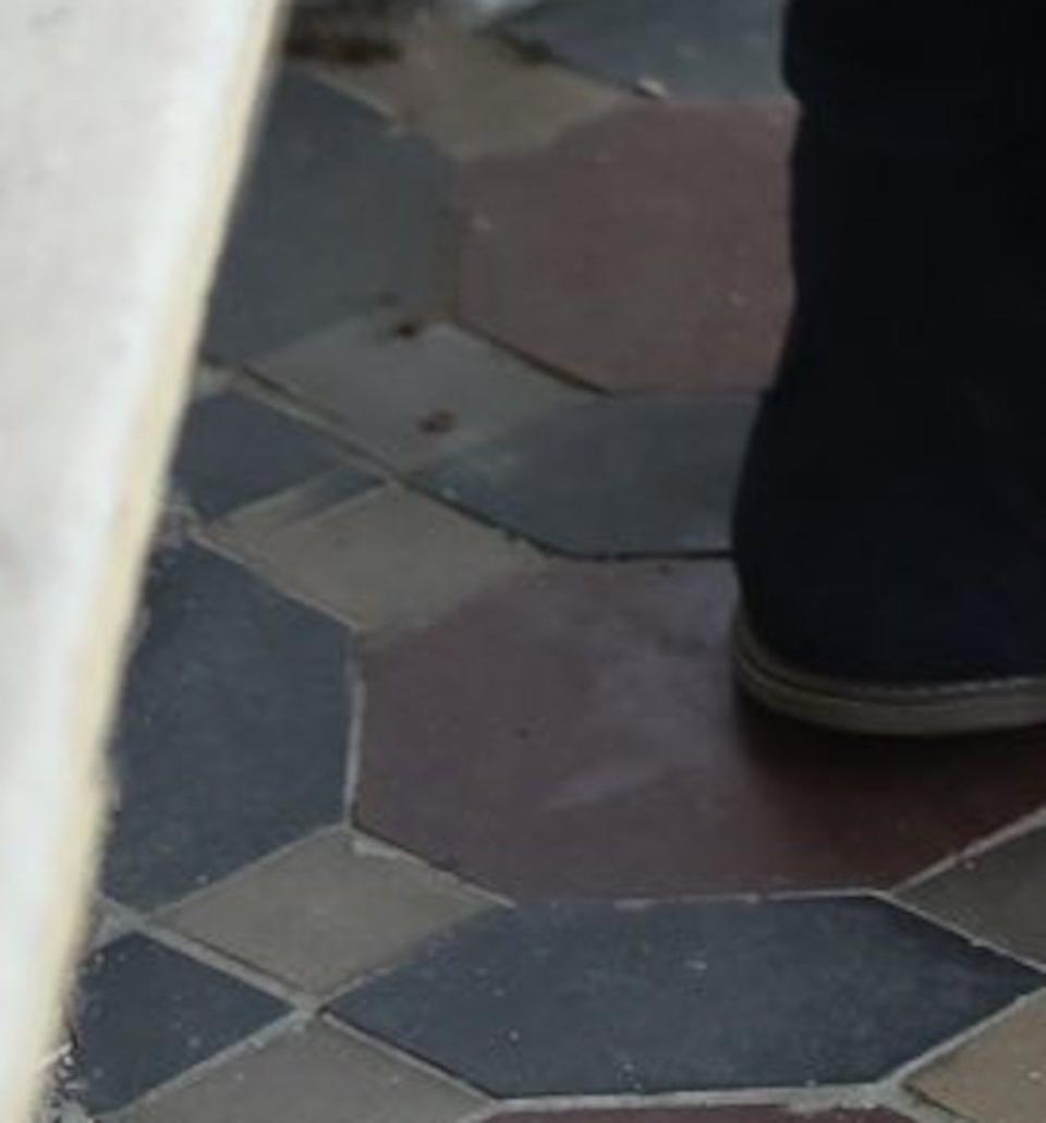 a person's feet on a stone floor