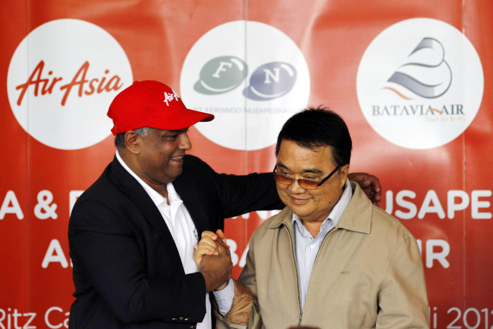 AirAsia Chief Executive Officer Tony Fernandez, left, greets Batavia Air President Director Yudiawan Tansari during a joint press conference in Jakarta, Indonesia, Thursday, July 26, 2012. Low-cost airline AirAsia said it is buying Indonesian budget carrier Batavia Air to expand in Southeast Asia's biggest economy. (AP Photo/Achmad Ibrahim)