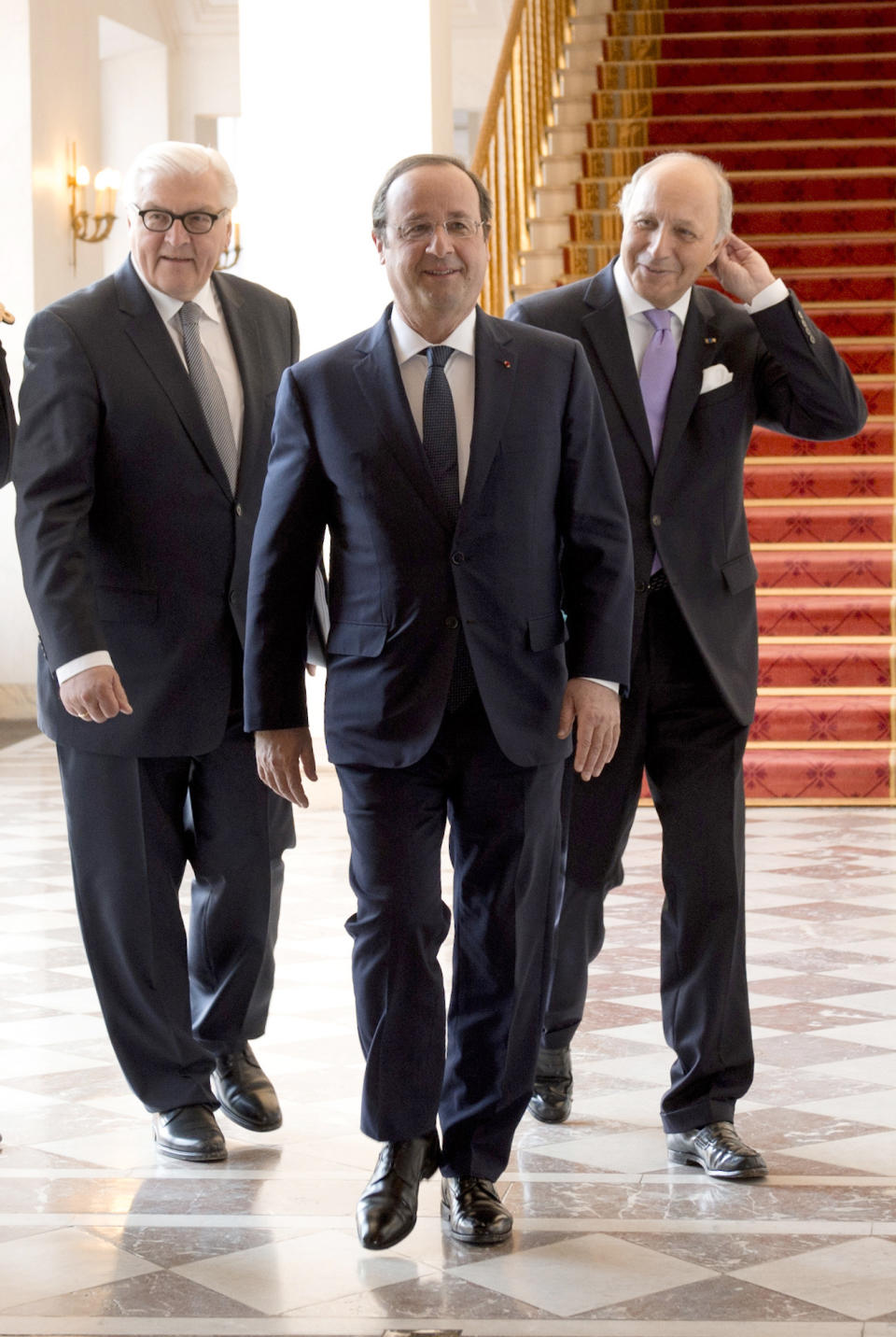 German Foreign Minister Frank-Walter Steinmeier, left, French President Francois Hollande, center, and French Foreign Minister Laurent Fabius arrive at the weekly cabinet meeting at the Elysee palace, Wednesday May 14, 2014, in Paris. (AP Photo/Alain Jocard, Pool)