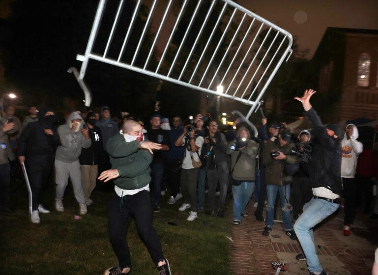 LOS ANGELES, CALIFORNIA - May 1: Pro-Palestinian protestors and pro-Israeli supporters clash at an encampment at UCLA early Wednesday morning. (Wally Skalij/Los Angeles Times)