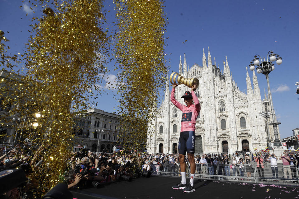 Colombia's Egan Bernal celebrates on podium after completing the final stage to win the Giro d'Italia cycling race, in Milan, Italy, Sunday, May 30, 2021. (AP Photo/Luca Bruno)