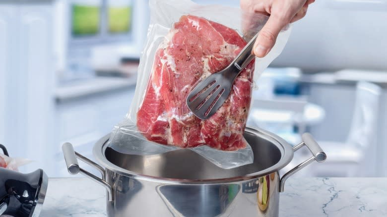 Vacuum sealed raw meat and pot