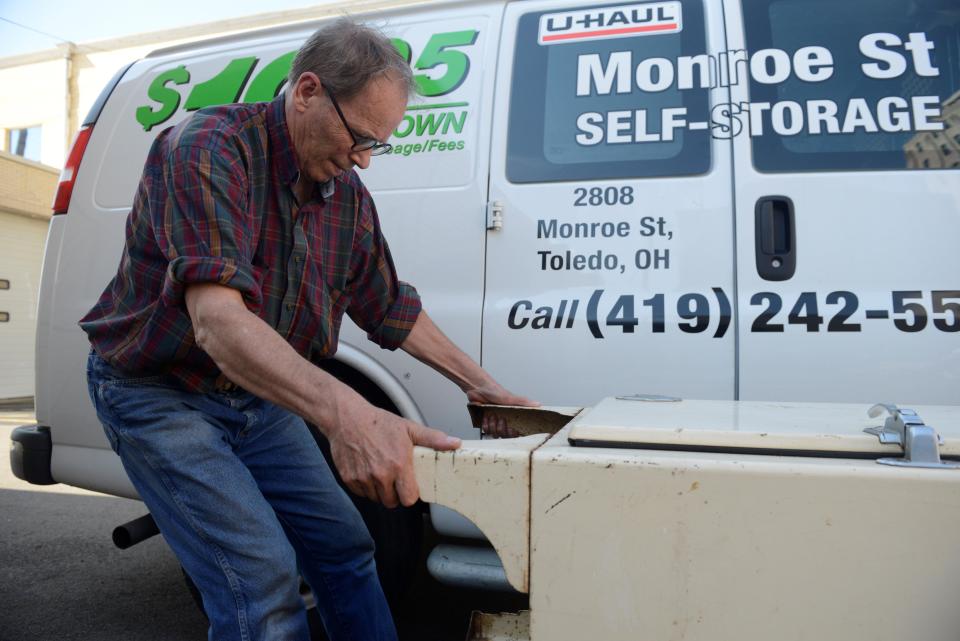 Scott Schaut, curator of the Mansfield Memorial Museum, hauls the 1930s-era refrigerator made by Westinghouse inside.