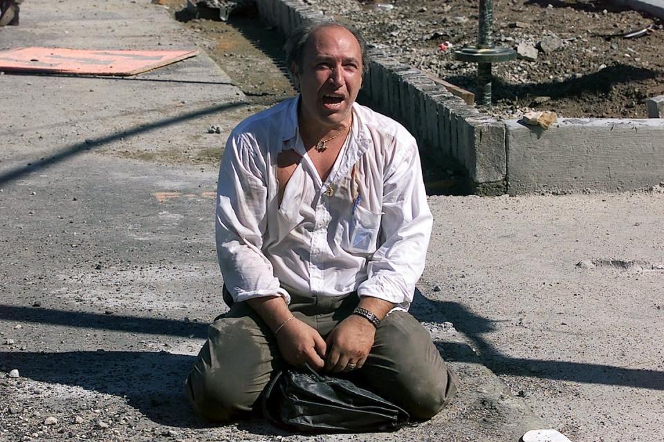 Remembering 9/11: A distraught survivor sits outside the World Trade Center after the terrorist attack. <a href="https://www.gettyimages.com/detail/news-photo/survivor-sits-outside-the-world-trade-center-after-two-news-photo/50833029?adppopup=true" rel="nofollow noopener" target="_blank" data-ylk="slk:Jose Jimenez/Primera Hora via Getty Images;elm:context_link;itc:0;sec:content-canvas" class="link ">Jose Jimenez/Primera Hora via Getty Images</a>