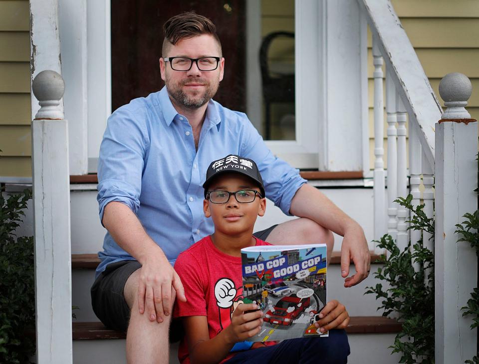 Nile Hennick, 11 of Milton, draws and his dad, Calvin, helps out with the writing of "Bad Cop vs. Good Cop." Friday, June 17, 2022.